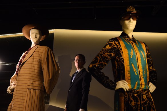 Senior Curator Roger Leong stands among mannequins in the Reigning Men: Fashion in menswear 1715-2015 exhibition at the Powerhouse Museum.