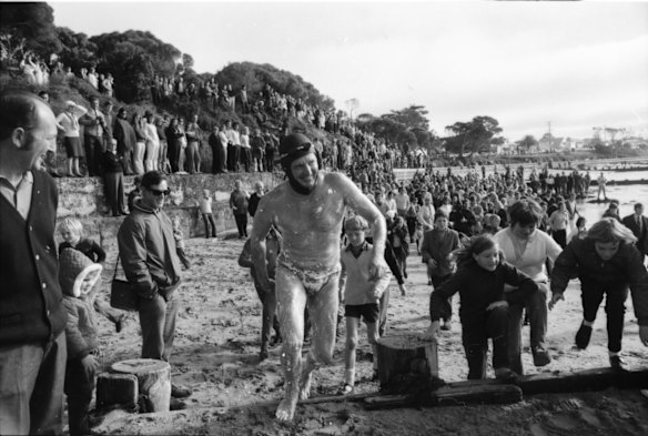 Used car dealer Doug Mew, 39,  runs along the beach at Point Lonsdale to start his swim across The Rip to Point Nepean.  Mew, swam The Rip, from Point Lonsdale to Point Nepean, in just under 70 minutes.

