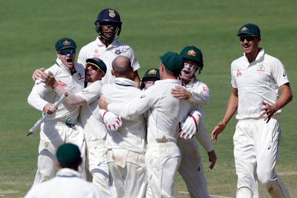 Australia's captain Steve Smith, left, and David Warner, second left, celebrate after winning the first cricket test match against India in Pune, India.