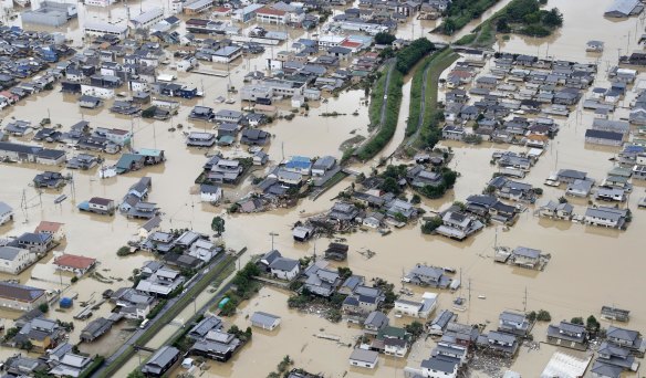 Houses are submerged by muddy water. Heavy rainfall hammered southern Japan for the third day.