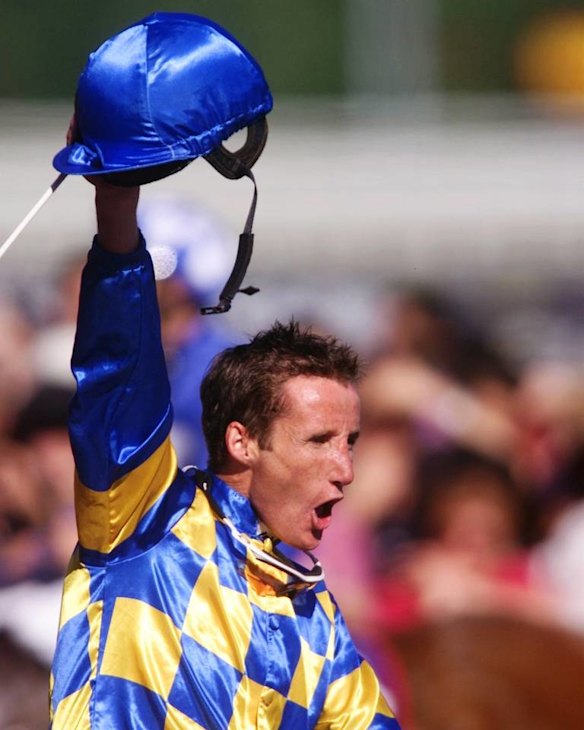 Damien Oliver celebrates his 1999 Caulfield Cup win on Sky Heights.