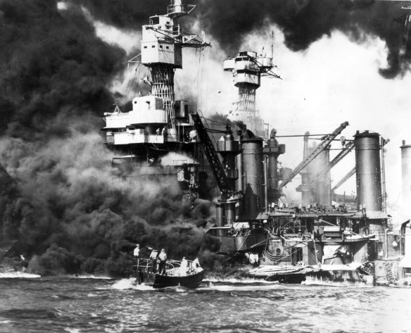 An American sailor is rescued from the sunken and burning battleship USS West Virginia during the Japanese attack on Pearl Harbour on December 7, 1941. 