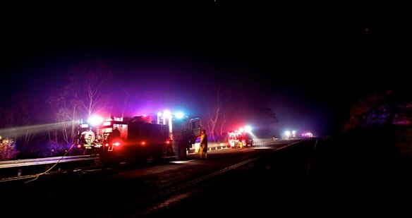 RFS fire crews in position along the Bells Line of Road west of Mt Tomah last night as fire threatened to jump the road from ember attack.