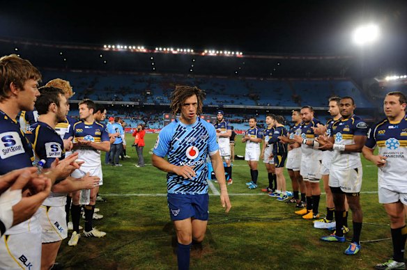 Zane Kirchner of the Bulls leaves the field acknowledged by Brumbies players.