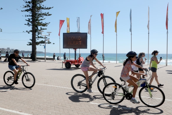 People ride bikes at Manly Beach on Sunday.