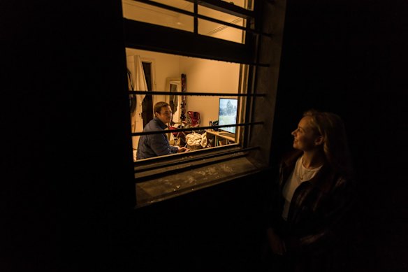 Tom Davis photographed on his tenth day of isolation after returning from a working holiday in Canada. Close friend and neighbour Olivia McLeod making one of her regular visits to chat at Tom's window.