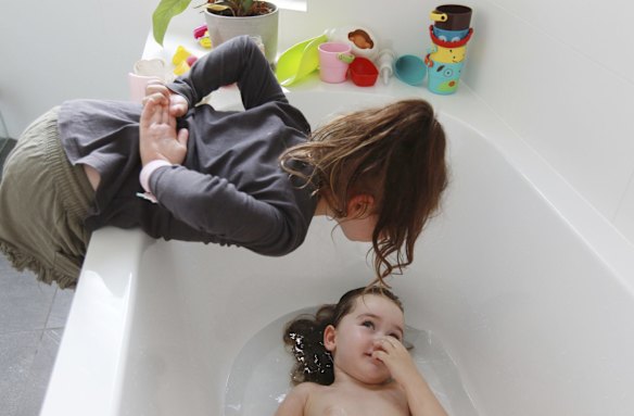 Sisters Florence and Grace enjoy a moment together at home. 