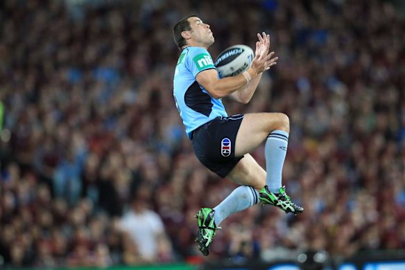 Blues winger James McManus jumps high for the ball.