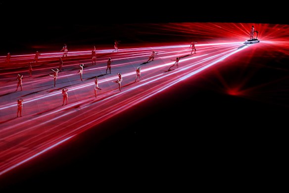 Performers dance during a light show.