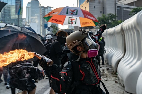 A pro-democracy protester throw a molotov cocktail outside the Central Government Complex on September 15, 2019 in Hong Kong, China.