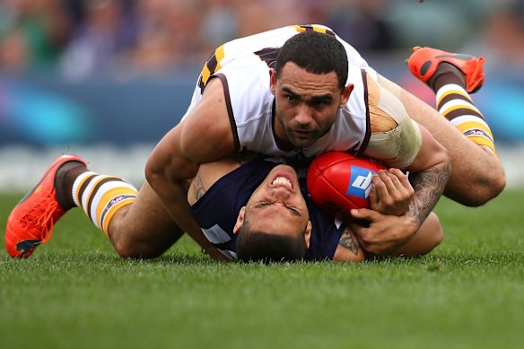 2014 Shaun Burgoyne of the Hawks tackles Fremantle's Michael Walters at Patersons Stadium.