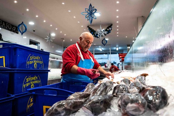 A fishmonger prepares fresh festive seafood supplies at the Sydney Fish Market.
