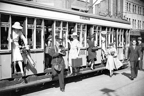 Passengers crowd on to tram services at Taylor Square going to Bondi and Maroubra.