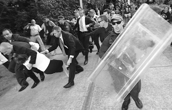 Prime Minister Julia Gillard is dragged by her security team during a hasty exit, during the Australia Day protest, in Canberra on 26 January 2012.