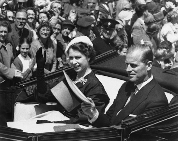 In this June 18, 1952 file photo, Queen Elizabeth II is driven in an open carriage from the Golden Gates at Ascot, Racecourse, Berkshire, England with Prince Philip, during the second day of the Royal Ascot meeting. 