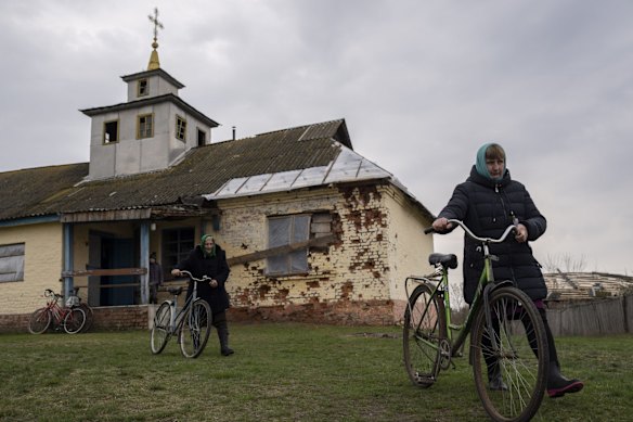 Women leave the damaged Pokrova church, on the outskirts of Chernihiv, after attending a Good Friday ceremony for the Orthodox Easter.