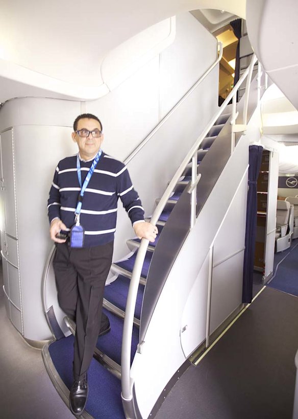 Boeing machinist Jose Diaz walks down the stairs on a Boeing 747-8 Intercontinental airliner.