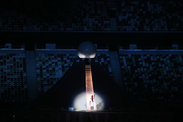  Naomi Osaka of Team Japan carries the Olympic torch towards the Olympic cauldron.