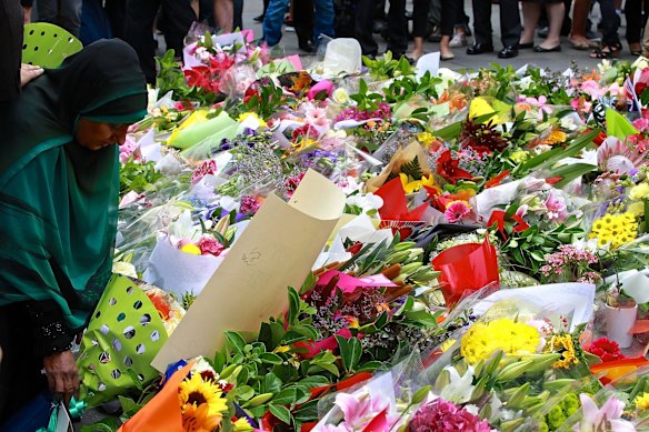 Flowers filled Martin Place on Tuesday as hundreds arrived to pay respects. 