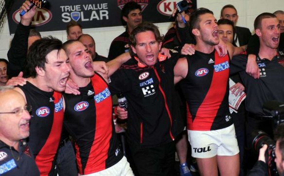 Happier days: James Hird joins in the team song after a big win over Carlton early in his initial tenure as Essendon coach.