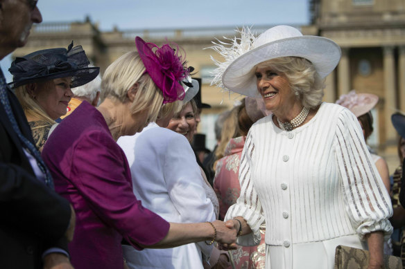 Camilla the Duchess of Cornwall greets guests during a pre-pandemic garden party at Buckingham Palace.