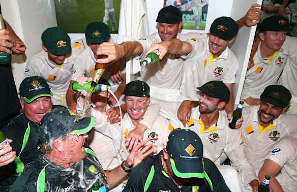 The Australian team celebrates victory in the change rooms.