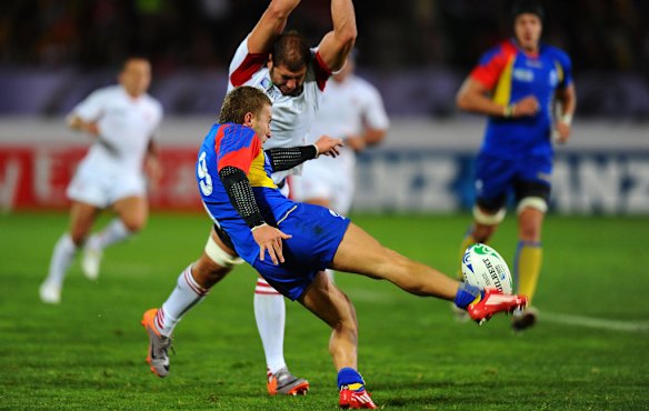 Scrumhalf Florin Surugiu of Romania clears the ball downfield as Giorgi Chkaidze