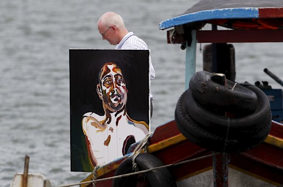 Lawyer Julian McMahon carries Myuran Sukumaran's self portrait of his upper body, with a black hole over his heart. 