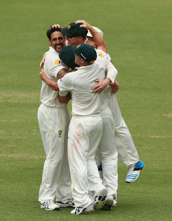 Mitchell Johnson of Australia celebrates with Chris Rogers after they combined to dismiss Tim Bresnan of England during day five of the Third Ashes Test Match.