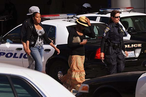 Unidentified members of the Jackson family are escorted by police officers into the UCLA Medical Center following the death of musical legend Michael Jackson.