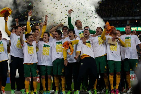 The Socceroos celebrate after defeating Iraq at the Olympic Stadium in Sydney.