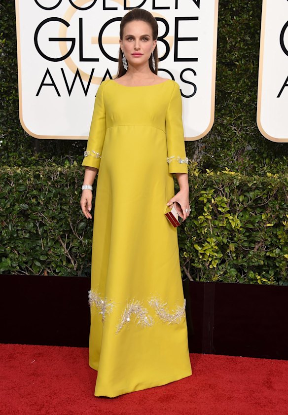 Natalie Portman channels Jackie on the red carpet with a mustard Prada gown and jewels from 1910.