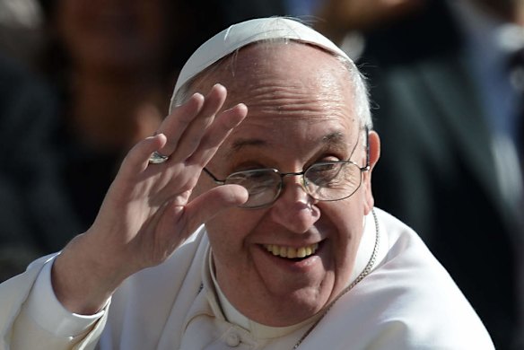 Pope Francis waves to the crowd from the papamobile during his inauguration mass.