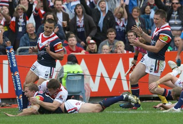 The Roosters Mitch Aubusson goes in for a corner try. 