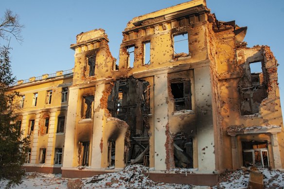 A damaged by shelling building is lit by sunset in Kharkiv, Ukraine, Friday, March 11, 2022.  