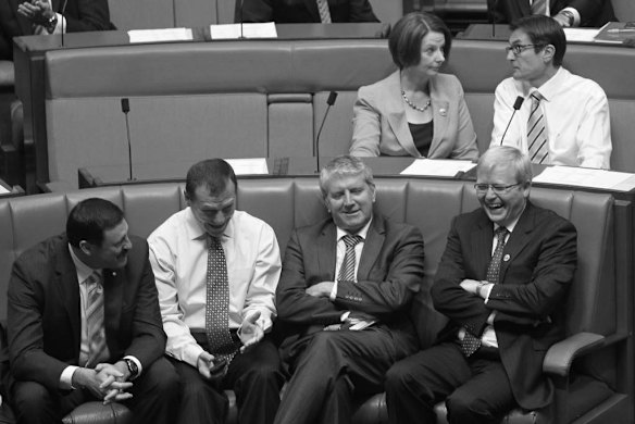 Foreign minister Kevin Rudd talks with L to R Defence parliamentary secretary Mike Kelly backbencher Graham Perrett and Human Services minister Brendan O'Connor as Prime Minister Julia Gillard and Climate Change minister Greg Combet vote to defeat Tony Abbott's amendments to the Medicare Levy Surcharge Bill at Parliament House Canberra on Wednesday 15 February 2012. The Bill later passed.