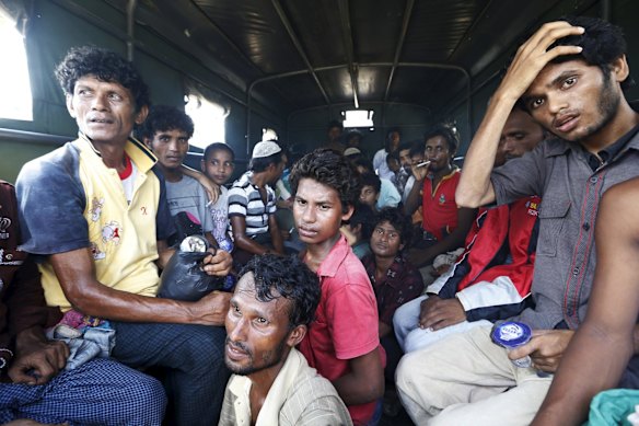 Bangladeshi migrants who arrived by boat sit inside military truck as they are transported to an immigration office at the port of Julok village in Kuta Binje, Indonesia's Aceh Province, May 20, 2015. Hundreds of Rohingya and Bangladeshi migrants landed in Indonesia's northwestern Aceh province early on Wednesday, an Indonesian search and rescue official said. 