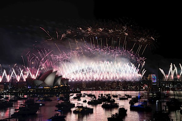 The New Years Eve Midnight fireworks light up the Sydney Harbour Bridge and Opera House.