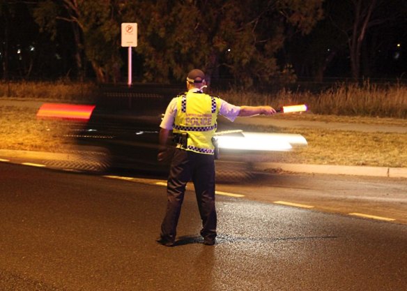 A police random testing stop. From Saturday, Canberra drivers must slow to 40km/h to pass emergency vehicles that have their lights flashing.