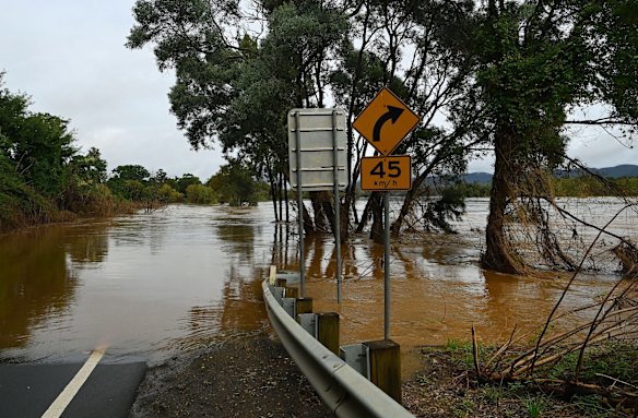 Water covers the road towards the Yarramundi Bridge which is also under water at the Nepean River in Agnes Banks.
