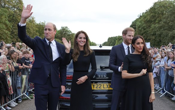 Catherine, Princess of Wales, Prince William, Prince of Wales, Prince Harry, Duke of Sussex, and Meghan, Duchess of Sussex wave to the crowd on the long walk at Windsor Castle.