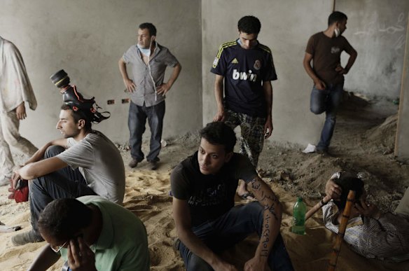Supporters of deposed Egyptian President Mohammed Morsi take shelter inside a construction site during a violent crackdown by Egyptian Security Forces on a pro-Morsi sit-in demonstration at the Rabaa al-Adweya Mosque in the Nasr City district in Cairo, Egypt.