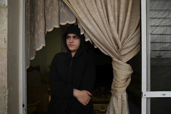 Nour Abdel-Jaleel Othman, 21 years old from Daraa in Syria looks out from her Aunty's rented apartment in Irbid town in Jordan. Nour lives with relatives as her mother died when Nour was 8 months old and her father is living in Austria with his new family. Nour dreams of  going to France. 
