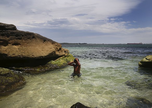 Crowds find refuge from the oppressive heat, swimming at Yarra Bay.