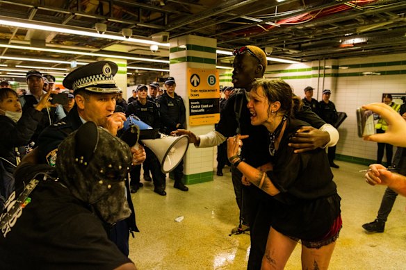 A small group clash with police at Sydney Central Station.