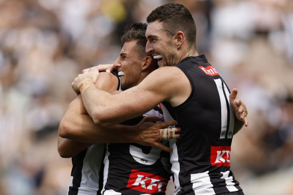 Happy days: Nick Daicos and Dan McStay celebrate a goal, as the Magpies remain unbeaten to start the new season.
