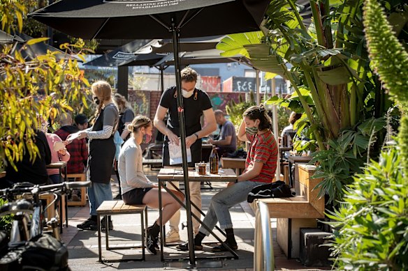 Customers enjoy dining at their local cafe in Brunswick.