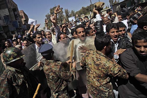 Anti-government demonstrators are blocked by anti riot police as they demand the resignation of President Ali Abdullah Saleh in Sanaa, Yemen.