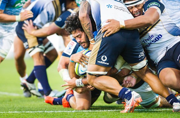 Blues' No.8 Akira Ioane uses brute strength to get over for a try in the second half. 
