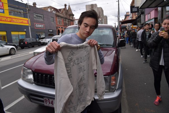 Nathan Coot shows his new purchase outside the Kanye West pop up store in Fitzroy. 